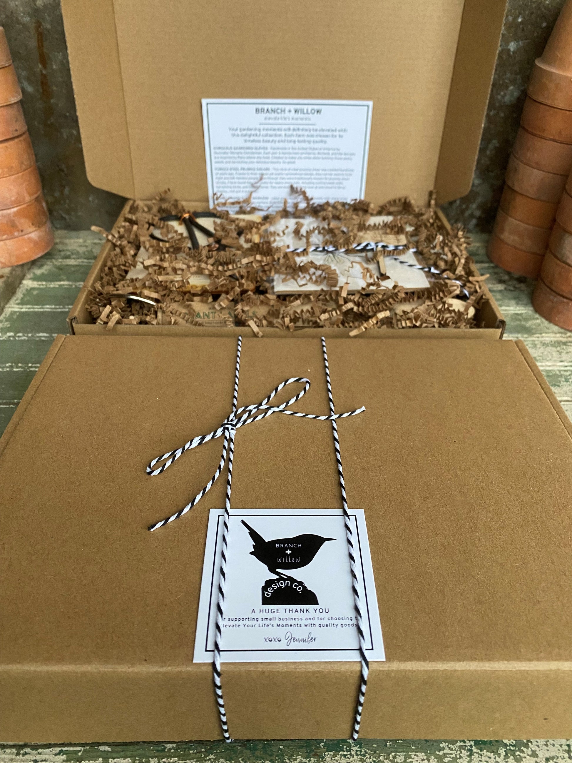 kraft box packaging tied with black and white twine and a thank you card